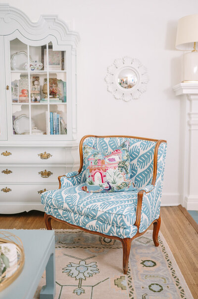 chair with blue and white leaf pattern sitting in a parlor room