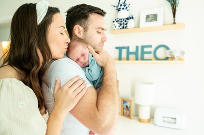 family in bed with a newborn boy  in home photography session
