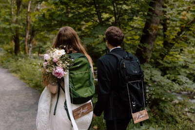 Elopement couple balancing on a log in front of a waterfall at the Columbia River Gorge.