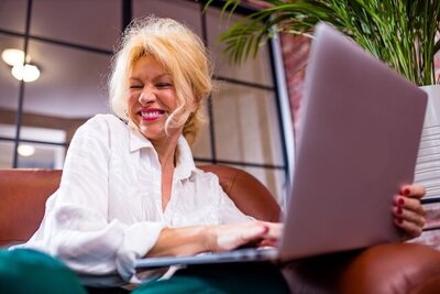 women enjoying herself while on an online call