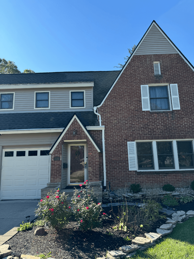 Completed exterior renovation on a brick house by Black Bear Roofing & Exteriors.