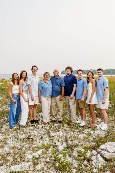 beautiful image of grandparents standing with their 7 grandchildren on a beach in Door County.