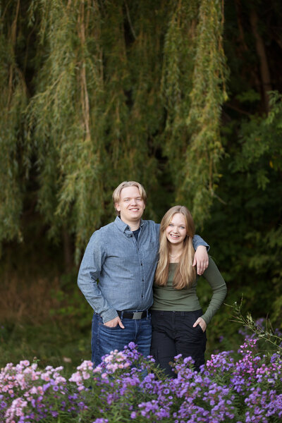 brother and sister smiling during  family pictures in Boise park with Tiffany Hix Photography