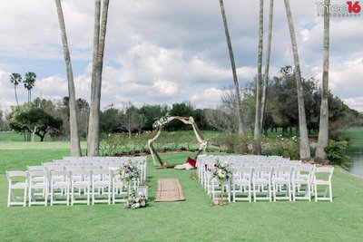 Outdoor wedding ceremony setup on a golf course
