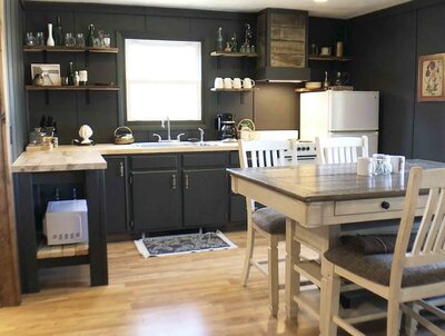 rustic kitchen with dark cabinets and tall kitchen table set