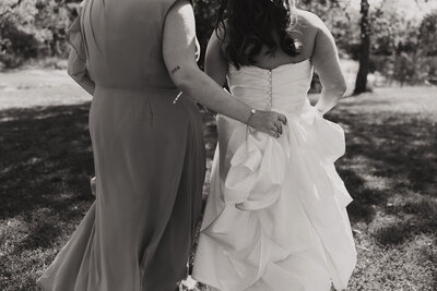 Woman carries the bride's train