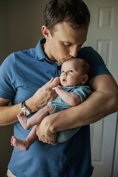 dad with his sone at a newborn session in Plano Texas