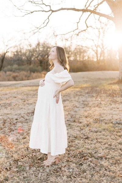 pregnant woman in white dress during sunset peoria, illinois maternity photos 