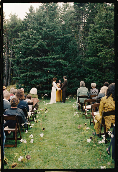 Intimate outdoor ceremony in the woods of Deer Isle, Maine | Coastal wedding with 35mm film documentary-style photography
