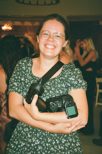photographer holding film camera in Blueberry Hill Estate, Paoli Indiana 
