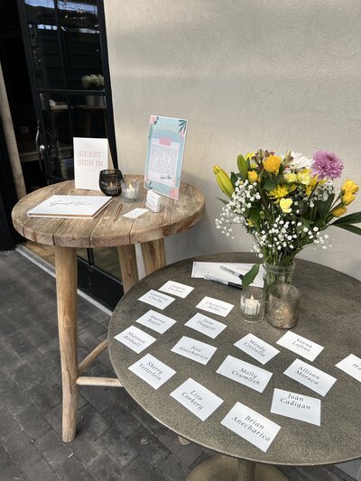 tables with sign in book and name cards