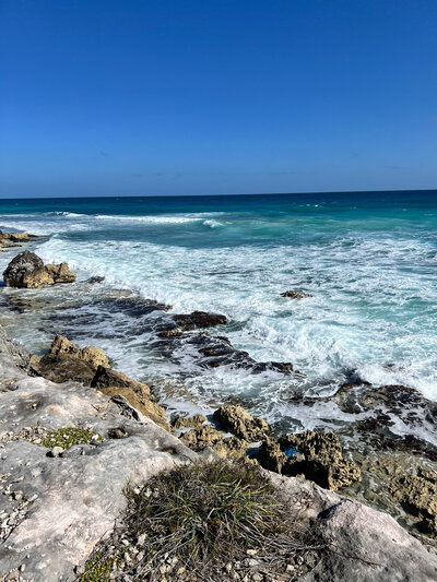 The stunning Caribbean coastline with rocky shores, creating a dreamlike backdrop for a destination wedding.