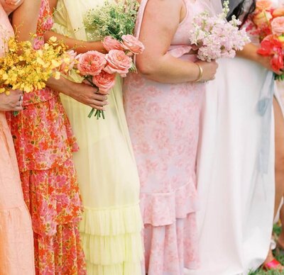 Bridesmaids holding colorful Sunrise Blooms bouquets