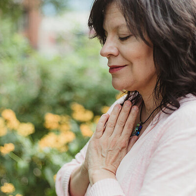 person smiling with their eyes closed letting go of thought loops