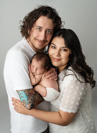 the perfect newborn family photo session ever. how sweet are these lovebirds during their newborn experience. so sweetly snuggled together as a new family of three. This family comes from stoney creek, ontario to see us at Meraki Photographic Creations in Paris, Ontario