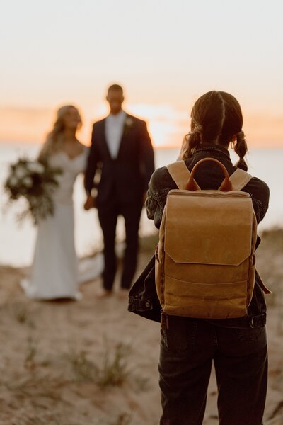 photographer capturing bridal couple walking