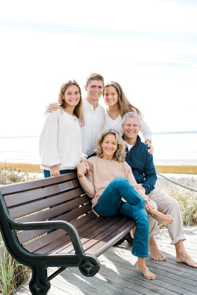 Family sitting on beach bench