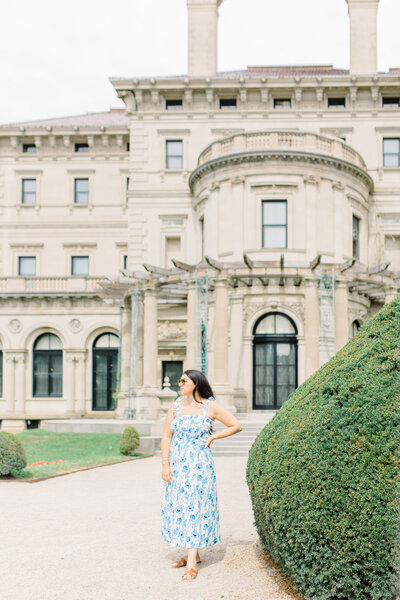 Francesca Leite in a blue and white dress posing in front of a building