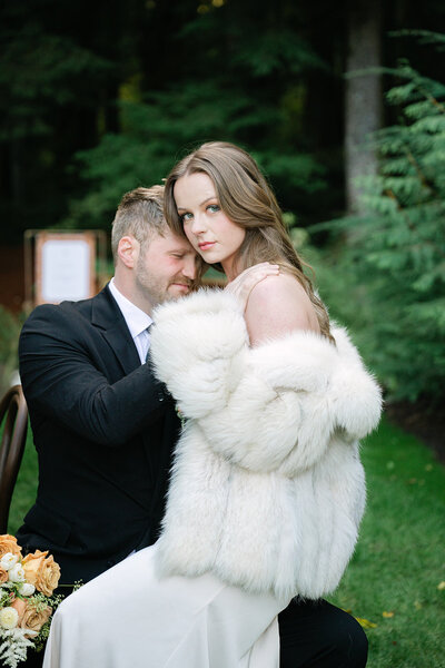 modern portrait of bride and groom in green landscape 