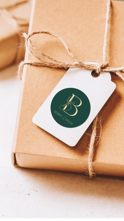 Brown wrapped gift with white tag hanging that has a Berry and Balm sticker