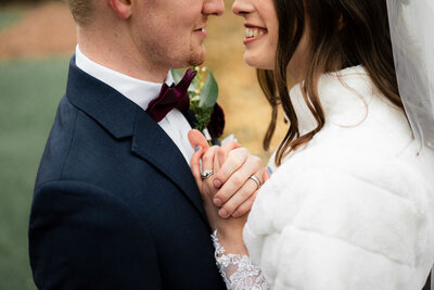 bride and groom smiling at each other and embracing