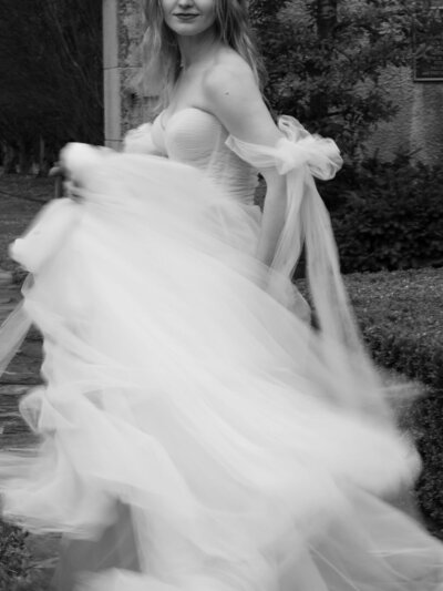 A bride in a Galia Lahav wedding gown twirls around in the lush gardens of the Philbrook Museum in Tulsa, Oklahoma.