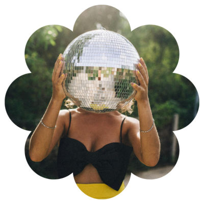 Woman hides head behind a disco ball