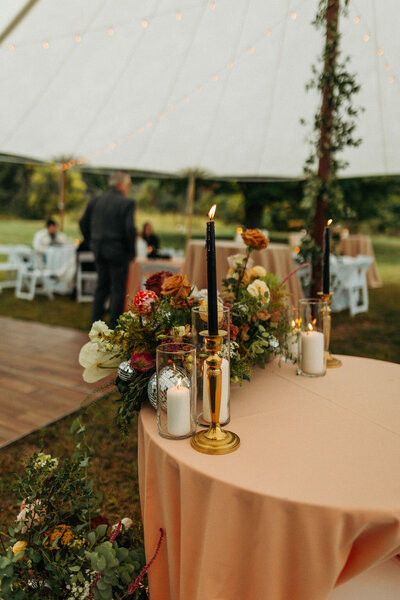 Picture of table with black and white candles and flowers