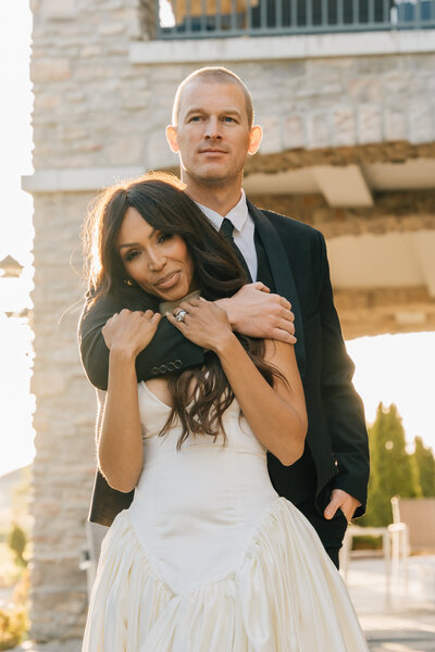 groom holding the bride from behind