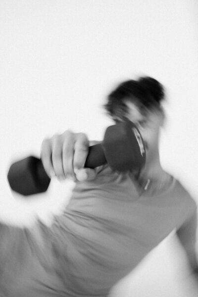 man holding a weight while working out