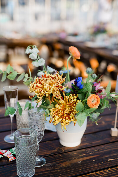 A detail of the wedding reception including the flower arrangements made by Moonlight Floral Co and crystalware at Dos Pueblos Orchid Farm.