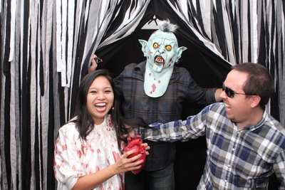 3 people smile for halloween photobooth