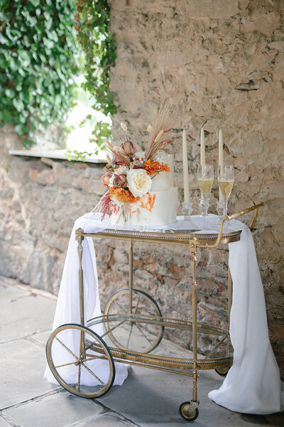 bar cart stands outside of a tuscan looking outdoor venue Goodstone Inn