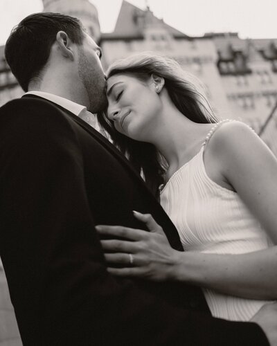 groom kisses bride on forehead sharing a tender intimate moment