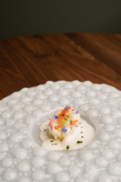Seared scallops with beurre blanc, salmon roe, French toast crumble, and dill oil at Revé