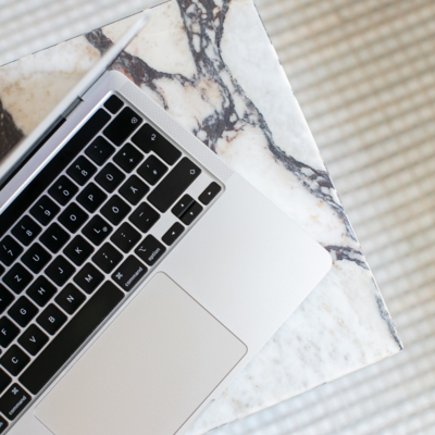 Laptop on marble surface — SEO services to grow traffic and improve visibility