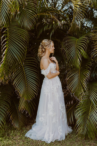 bride standing in front of tree branches