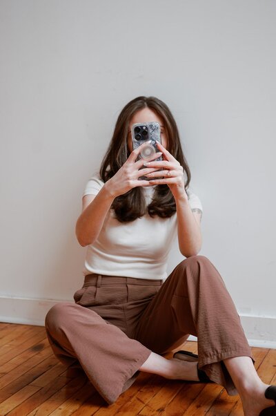 Liz holding her phone in front of her face