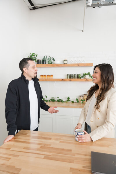 Professionals at Romo CPA Tax + Advisory in Dallas, TX, delivering strategic CPA services for entrepreneurs during a meeting in a sophisticated space, dressed in branded colors.