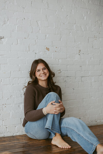 portrait photo of girl with long brown hair against rustic wall |Magnolia Tree Weddings| Wedding event planner 