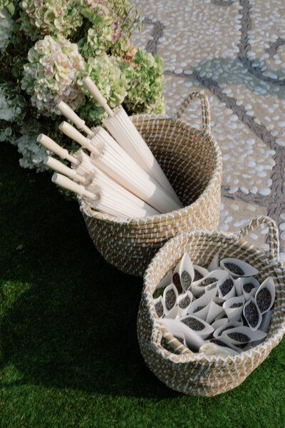 Wedding reception table decor close up, a wooden table, white plates, and a white runner with candles and flowers