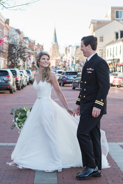 Naval Academy wedding photo of couple on Main Street in Downtown Annapolis by Christa Rae Photography