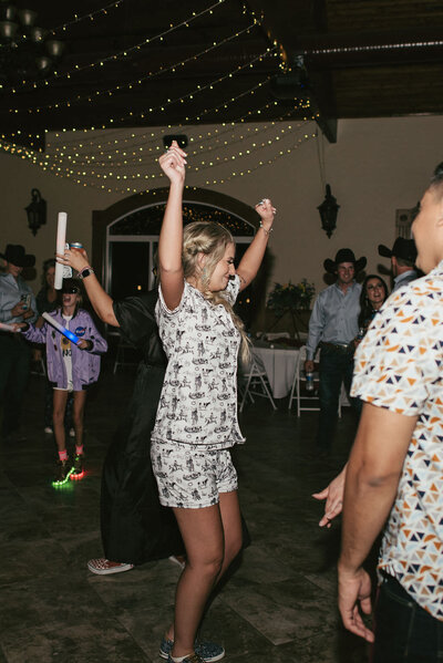 Bride dancing in her PJs during reception