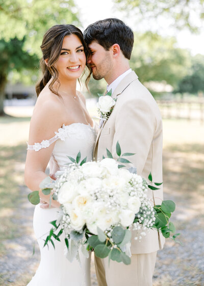 Lauren and Zac smiling together at their countryside wedding, highlighting Abby Bell Photography's expertise as an Alabama couples and engagement photographer.