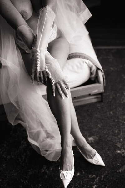 woman sitting showing her legs with heels