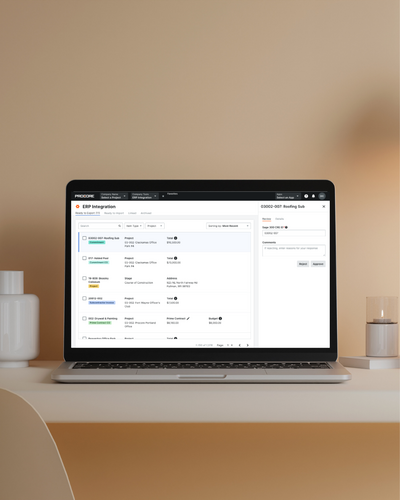 A computer is open to show the redesigned Procore Accounting Integrations design and user experience