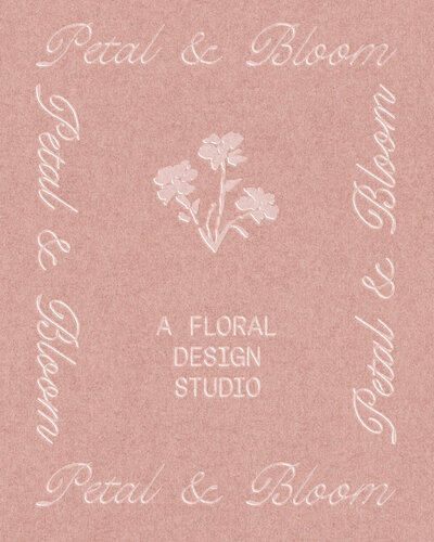 a pink business card with a script font and floral illustration