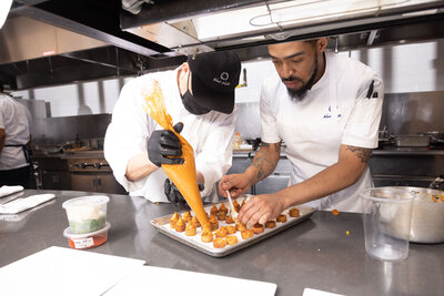 Two chefs preparing food