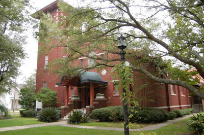 Exterior photo of t. Joan of Arc Building, trees