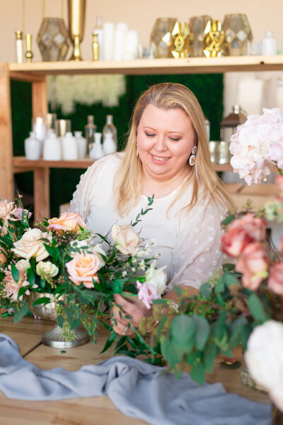 Natasha Larson  designing a low flower centerpiece in her Murfreesboro floral studio
